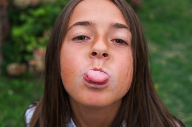 What does it mean when a girl sticks out her tongue? 