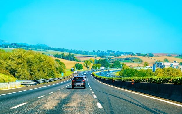 When driving in the right lane of a four lane highway you see a car coming up behind you? 