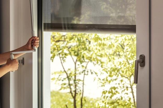 How do I lock a window screen in place? 