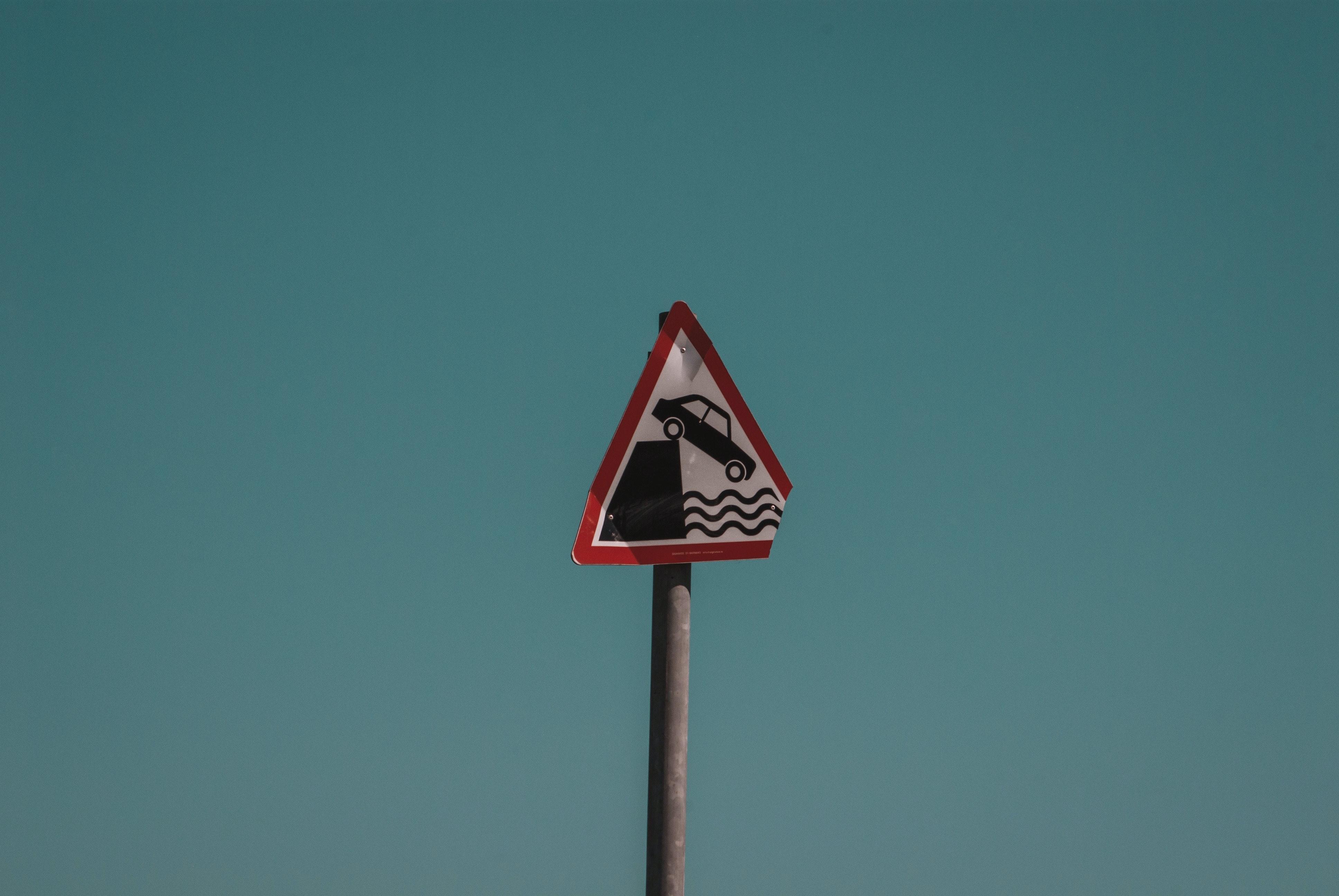 What type of sign warns you that you should slow down for a sharp rise in the roadway? 