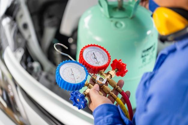 Where is the air conditioning recharge valve located? 