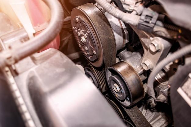 Where is the belt tensioner located? 