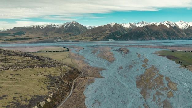 Why do meandering rivers meander across their floodplain? 